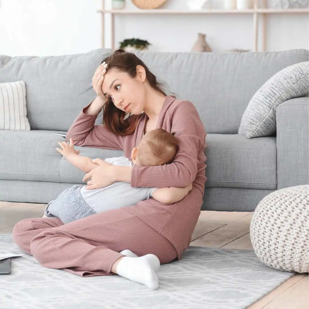 Depressed Mother Cuddling Newborn Baby